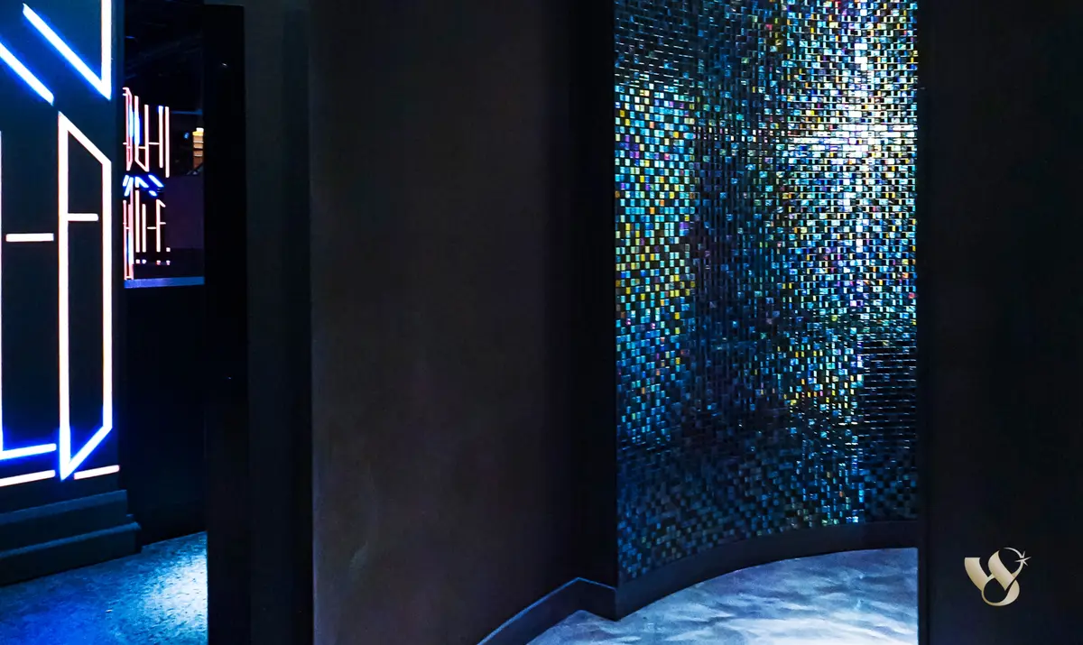 Iridescent mosaic tile wall in the entry corridor at West 8