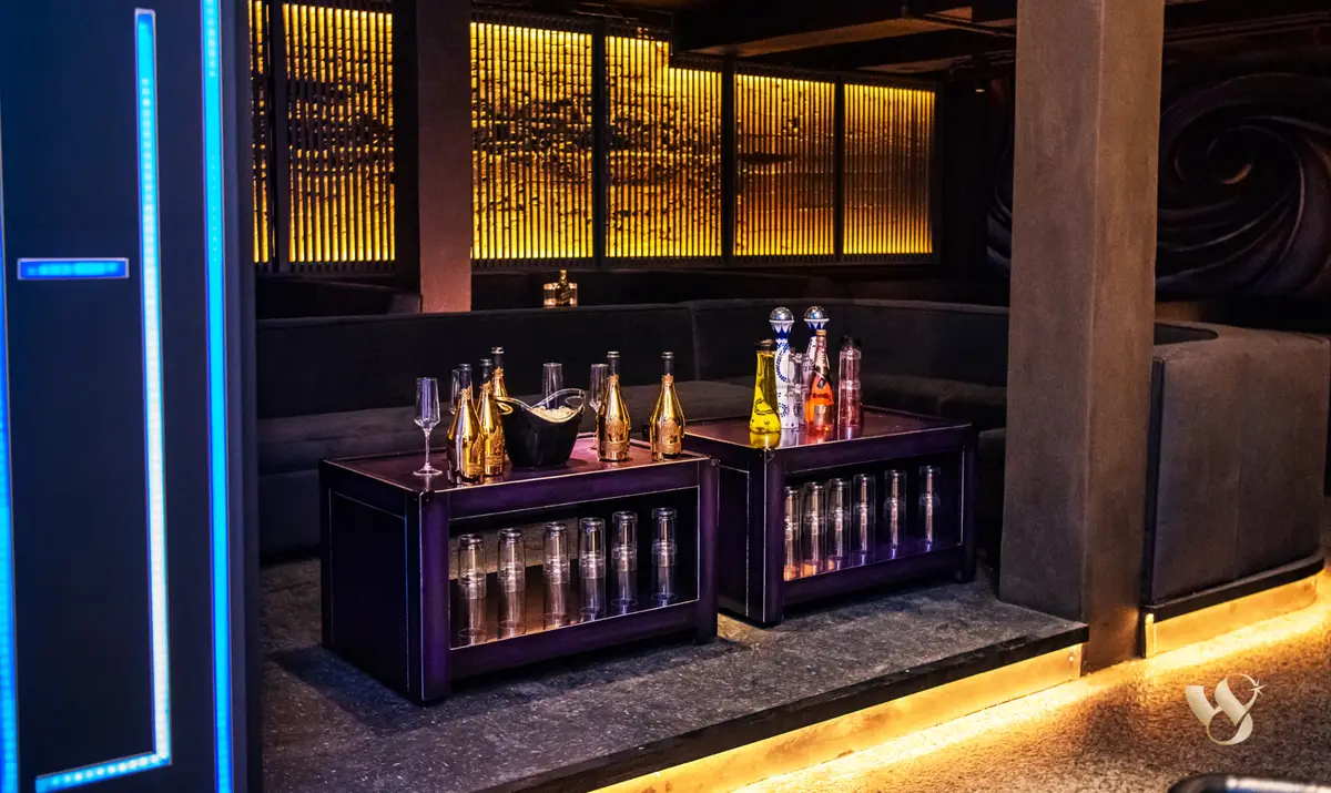 Bottle service on the table at West 8, gold-lit lounge